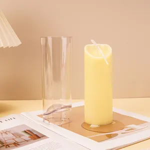 Detail of acrylic DIY candle mold showing finished wave-top cylindrical wax candle