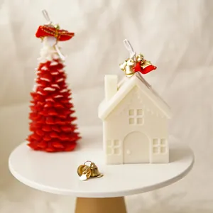 Close-up detail view of finished house and Christmas tree shaped scented candles on a stand