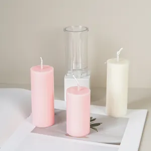 Transparent cylindrical plastic candle mold for DIY aromatherapy with sample pink candles