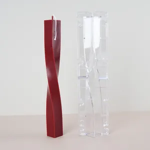 Clear acrylic twisted column candle mold shown with finished red spiral candle demo.