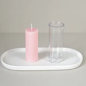 Integrated cylindrical DIY plastic candle mold with a finished pink pillar candle