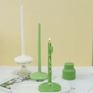 Elegant green and white taper candles with round bases for stylish home decoration