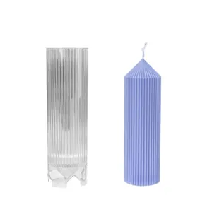 Striped pillar candle mold with pointed top and sample purple candle on white background.