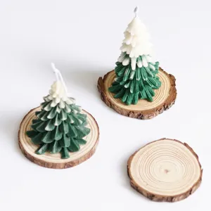 Detailed macro view of Christmas tree scented candles on natural pine wood coasters.