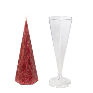 DIY hexagonal cone candle mold with textured red wax candle sample.