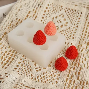 Detailed view of a strawberry silicone mold with realistic fruit finished products.
