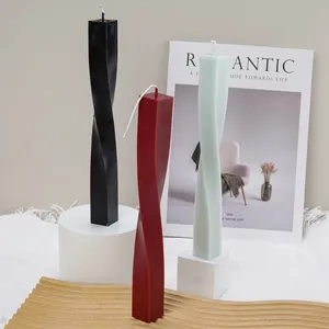 Modern geometric square spiral twisted pillar candles in black, red, and blue.