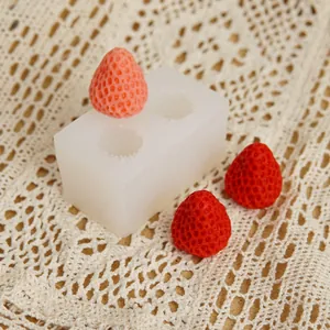 Macro detail of a two-cavity strawberry silicone mold for DIY resin candle craft