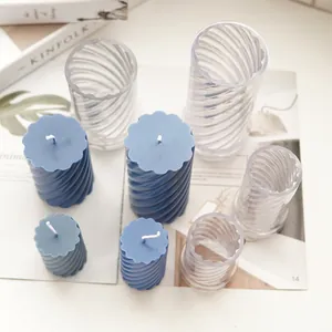 Detailed view of blue spiral pillar candles and clear PC plastic molds for DIY aromatherapy.
