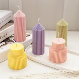 Group view of colorful geometric ribbed scented candles in various pillar shapes