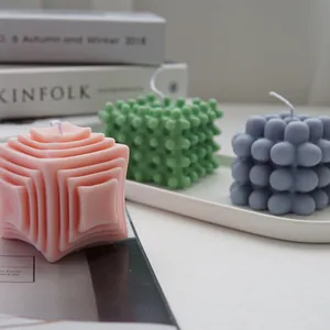 Close-up of geometric bubble and striped textured candles made from silicone molds