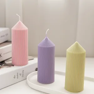 Close-up showing fine ribbed texture of pointed scented candles in pastel colors