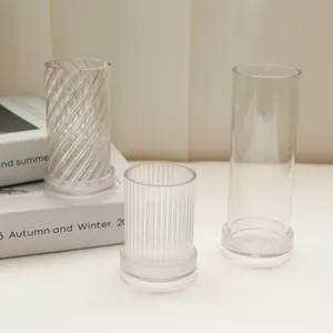 Set of three transparent cylindrical candle molds with spiral and ribbed textures