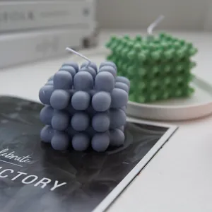 Close-up of a pastel purple bubble cube candle set on a minimalist lifestyle magazine