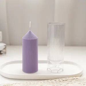 Detailed view of a purple ribbed pillar candle and its transparent plastic mold