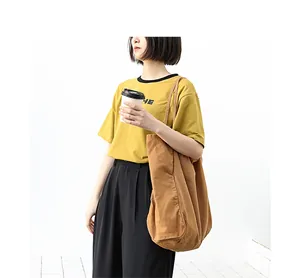 Lifestyle shot of a large retro washed canvas tote bag in earthy brown for daily use