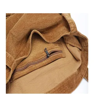 Close-up detail of the interior zipper pocket and corduroy texture of the tote bag