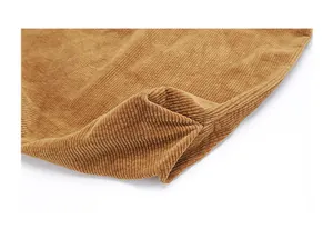 Detailed macro view of high-quality brown corduroy fabric texture and stitching