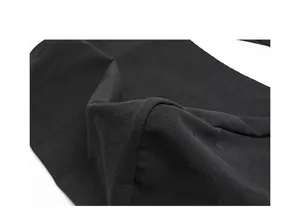 Macro view of the thick black canvas fabric texture for this vintage washed shoulder bag