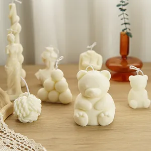 Collection of cream white aromatherapy candles in various artistic shapes like bears and Venus