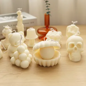 Collection of creative white aromatherapy candles in shell, skull, and bear shapes