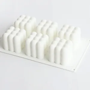 Close-up of a white 6-cavity bubble cube silicone mold for DIY aromatherapy candle making.