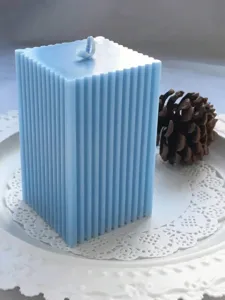 Detailed macro view of a light blue ribbed pillar candle with a fine-toothed texture