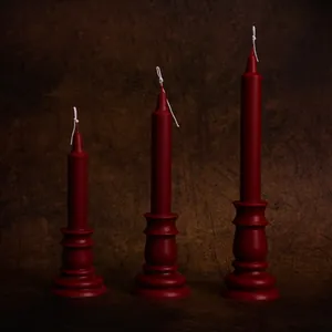 Vintage European style red taper candles in three heights with integrated pedestal bases