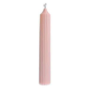 Elegant handmade pink ribbed pillar candle with tapered top for creative home decor