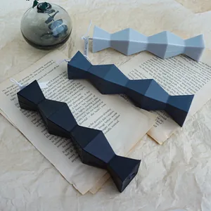 Creative Nordic style geometric abstract pillar candle molds displayed on vintage book pages