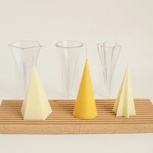 Detail view of geometric acrylic candle molds including finished cone and star candles