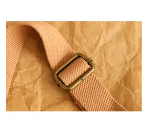 Close-up of the antique bronze adjustment buckle on a retro fabric bag shoulder strap