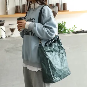 Vintage dark green DuPont paper tote bag with crinkled texture in a lifestyle shot