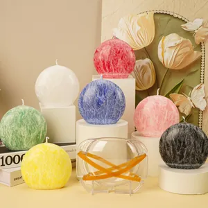 Close-up of clear moon candle mold and finished multi-colored aromatherapy candles