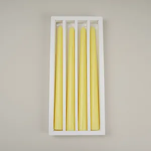 Set of 4 yellow tapered candles in a white minimalist divider gift box