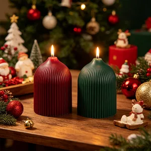 Detailed macro view of red and green ribbed dome candles in a festive Christmas setting