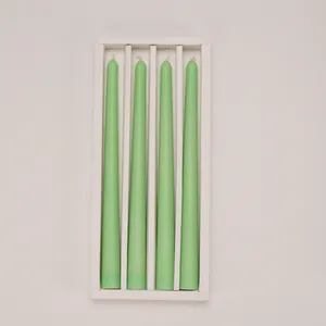 Pack of 4 long mint green taper candles in white protective gift box packaging