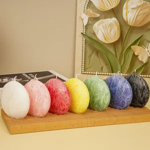 Close-up of seven colorful flat moon-shaped candles with unique crystal textures