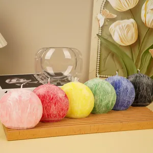 Transparent PC plastic mold shown with finished colorful textured sphere candles