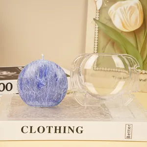 Detailed view of clear PC plastic moon-shaped candle mold and blue textured finished candle