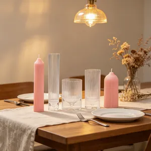 Detailed view of vertical ribbed candle molds and pink pillar candles on a dining table