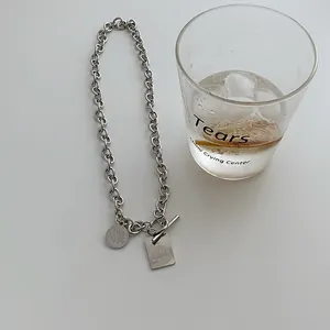 Chunky silver chain necklace featuring 'LOVE' and 'GRACE' engraved metal pendants