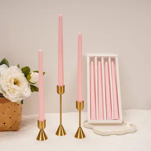 Set of 4 elegant pink taper candles with minimalist gold metal holders for wedding banquets