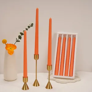 Set of 4 elegant orange tapered candles with gold holders for romantic wedding decor