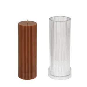 Detailed view of a cylindrical ribbed acrylic candle mold and finished brown wax candle.