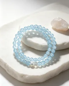 Detailed macro shot of blue chalcedony beaded bracelet with a single white pearl