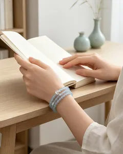 Close-up of light blue chalcedony beaded bracelet with white agate on model's wrist