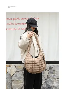 Beige quilted nylon shoulder bag with pleated texture shown on a fashion model in a street style