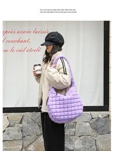 Lifestyle view of a purple quilted nylon shoulder bag with pleated texture on a model.