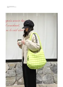 Model carrying a large lime green quilted hobo shoulder bag in a trendy street style.